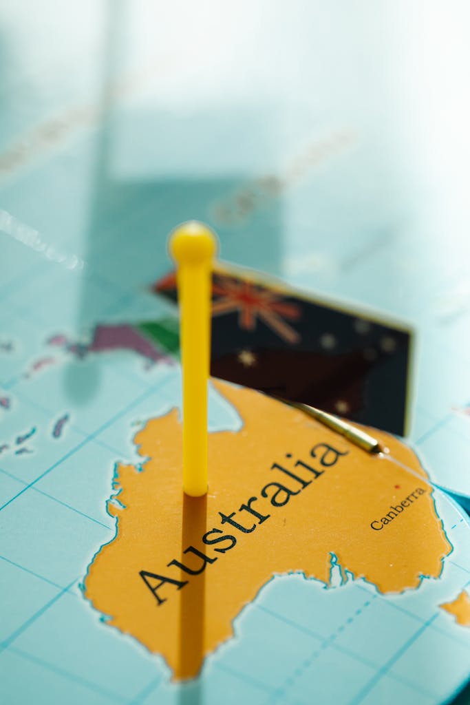 Close-up of Australia on the World Map and a Plastic Flag - property investment strategies