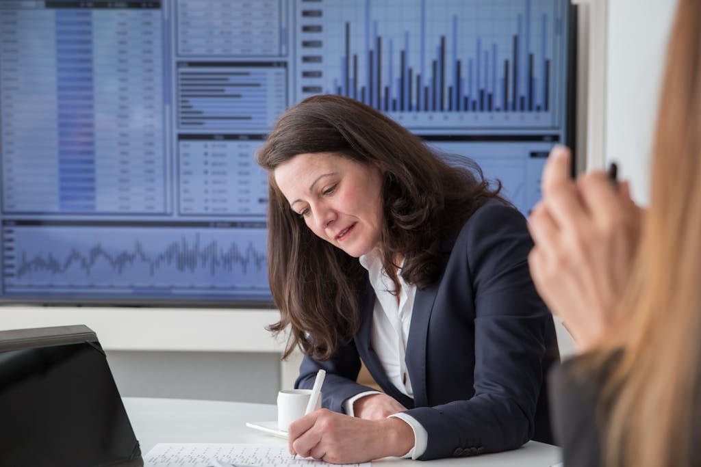 A Woman Wearing a Blazer Working - areas to invest in property