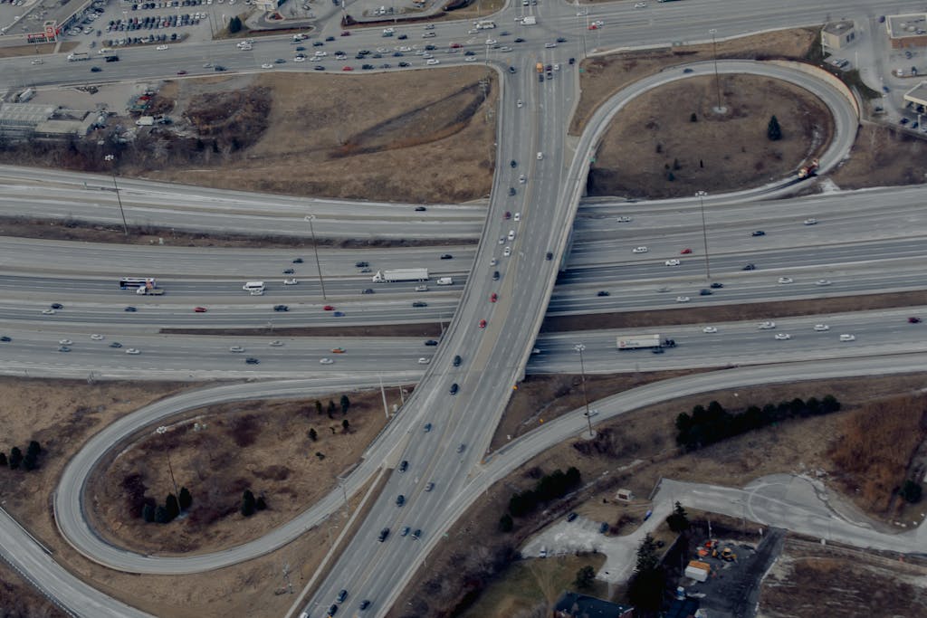 Cars driving on asphalt winding road of freeway - best areas to invest in property